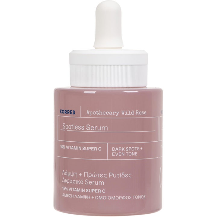 Korres Apothecary Wild Rose Spotless Serum kirkastava C-vitamiiniseerumi vaaleanpunaisessa lasipullossa valkoisella pipetillä.