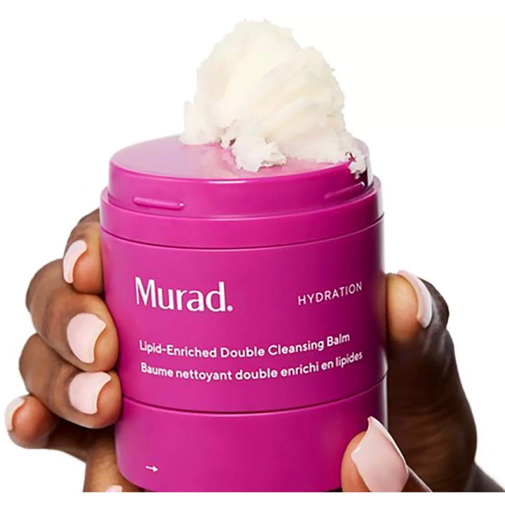 Murad Lipid-Enriched Double Cleansing Balm 50 ml kosteuttava puhdistusvoide pinkissä purkissa valkoisella tekstuurilla.