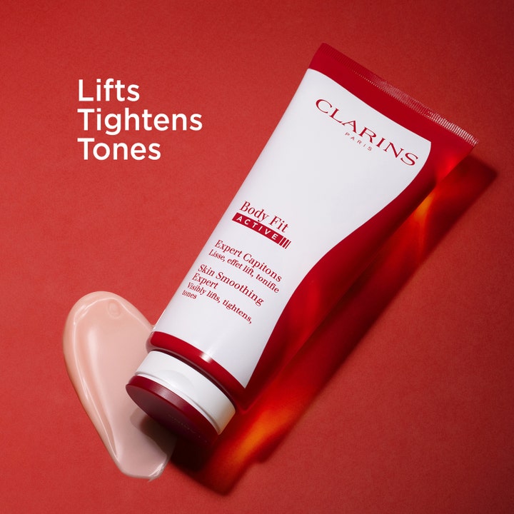 Clarins Body Fit Active 200 ml silottava vartalovoide punaisessa tuubissa vaaleanpunaisella voidekoostumuksella