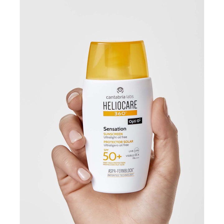 Heliocare Sensation SPF 50+ 50 ml öljytön aurinkovoide kasvoille valkoisessa pullossa keltaisella korkilla.
