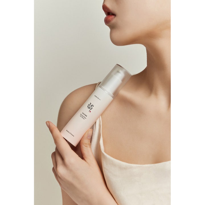 Beauty of Joseon Ginseng Moist Sun Serum 50 ml kosteuttava aurinkoseerumi naisen kädessä ja olkapäällä