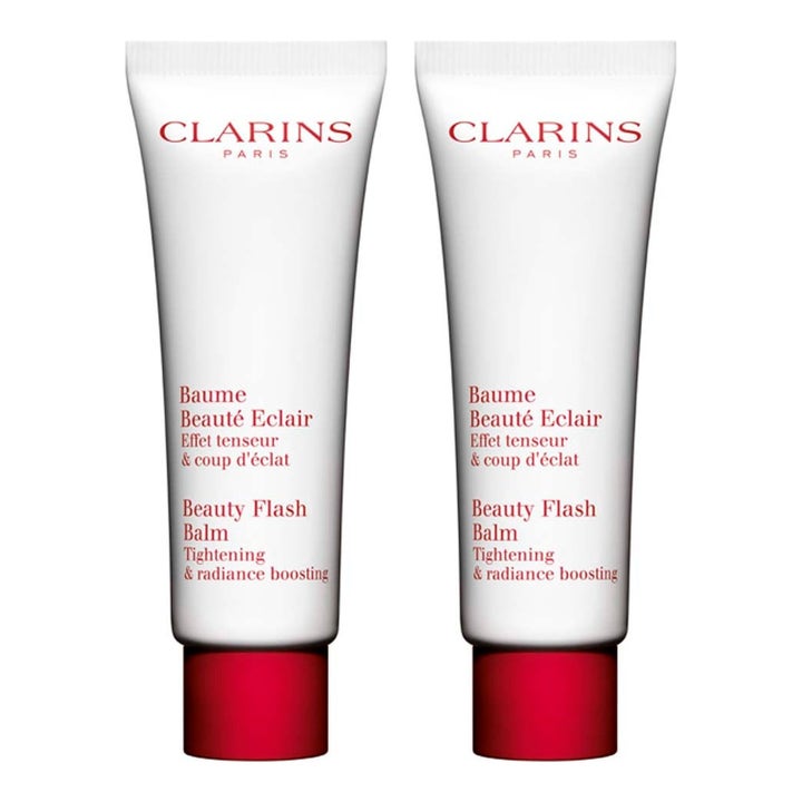 Clarins Beauty Flash Balm kirkastava ja kiinteyttävä voide kahdessa valkoisessa tuubissa joissa on punaiset korkit