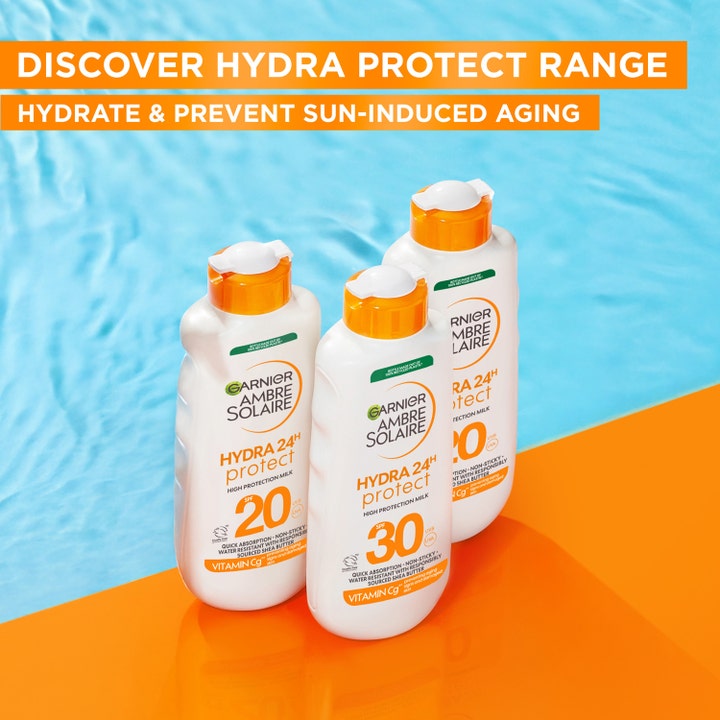 Garnier Ambre Solaire Hydra 24H Protect 175 ml kosteuttava aurinkovoide kolme valkoista pulloa uima-altaan äärellä