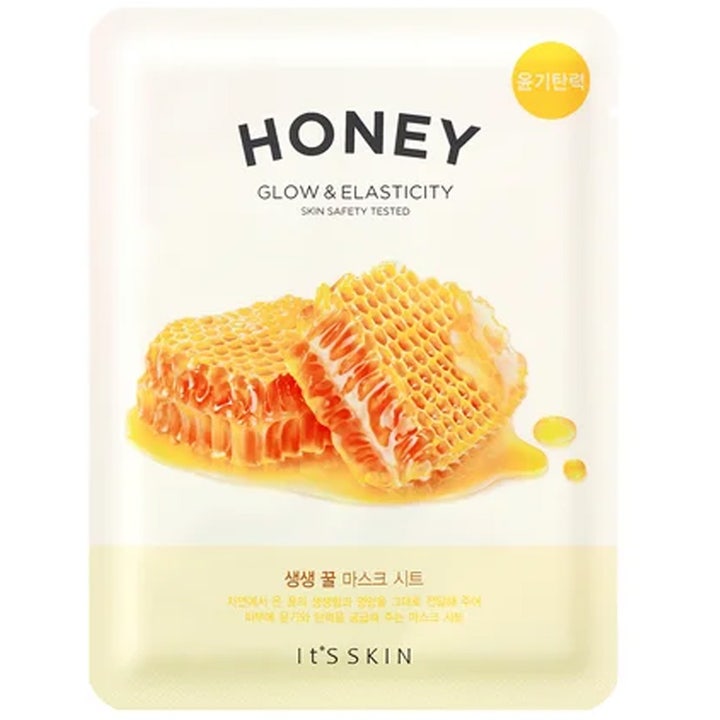 It's Skin Honey Glow & Elasticity 1 kpl heleyttävä kangasnaamio valkoisessa pakkauksessa hunajakennoilla.