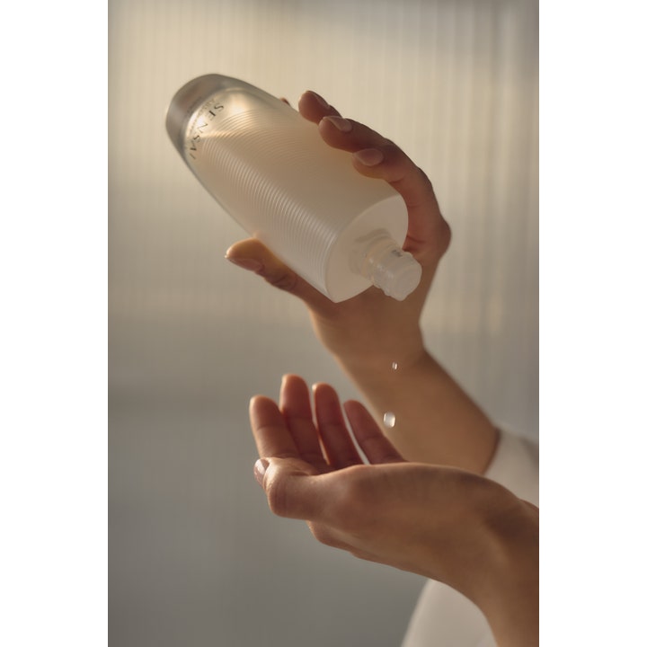 Sensai Absolute Silk Micro Essence-In-Lotion 125 ml tehokosteuttava seerumi tippuu kämmenelle.