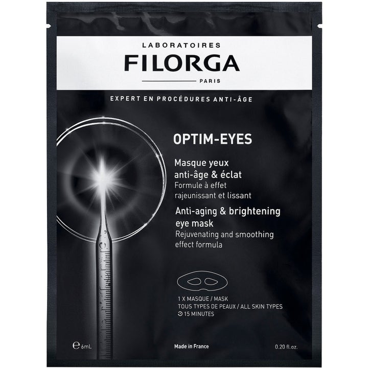 Filorga Optim-Eyes 1 kpl kirkastava ja silottava silmänympärysnaamio mustassa pussissa jossa on graafinen pipettikuvio