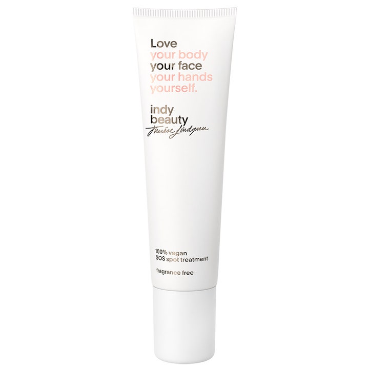 Indy Beauty SOS Spot Treatment täsmähoito epäpuhtauksille valkoinen kapea tuubi mustalla ja vaaleanpunaisella tekstillä.
