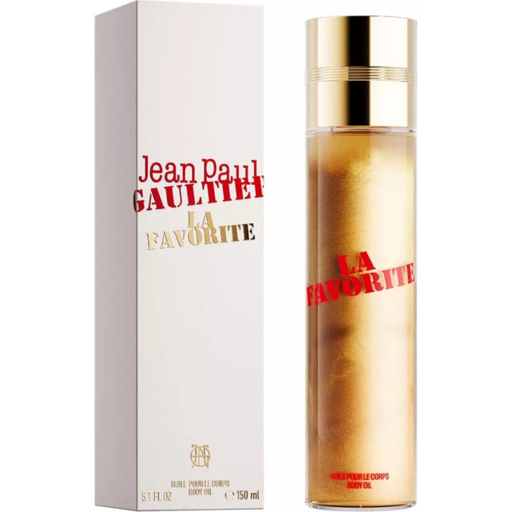 Jean Paul Gaultier La Favorite 150 ml heleyttävä vartaloöljy kultaisessa pullossa valkoisen pakkauksen vieressä