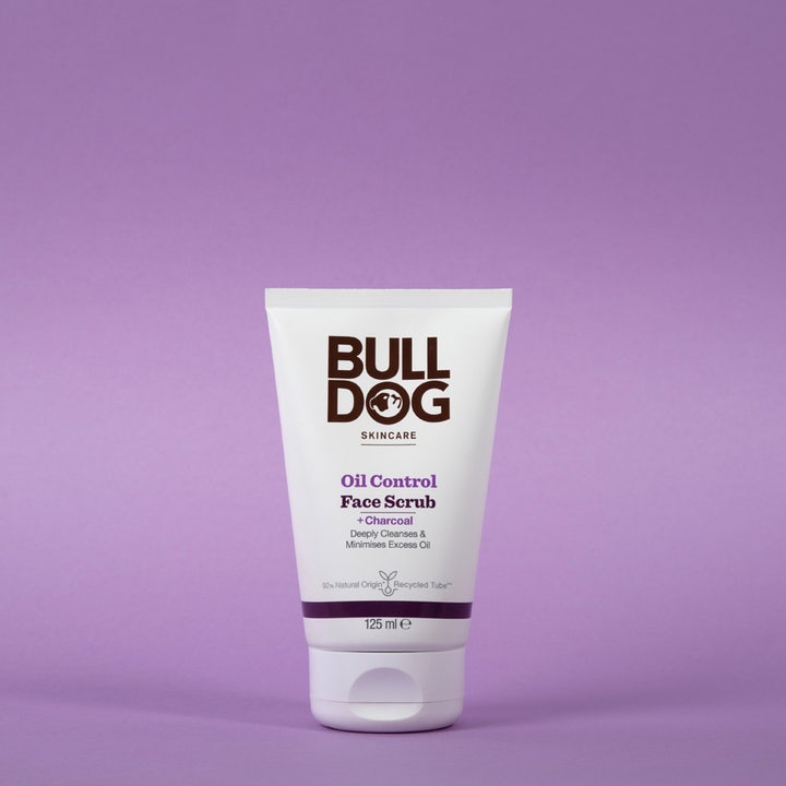Bulldog Oil Control Face Scrub 125 ml syväpuhdistava kasvokuorinta hiilellä valkoisessa tuubissa lilalla taustalla