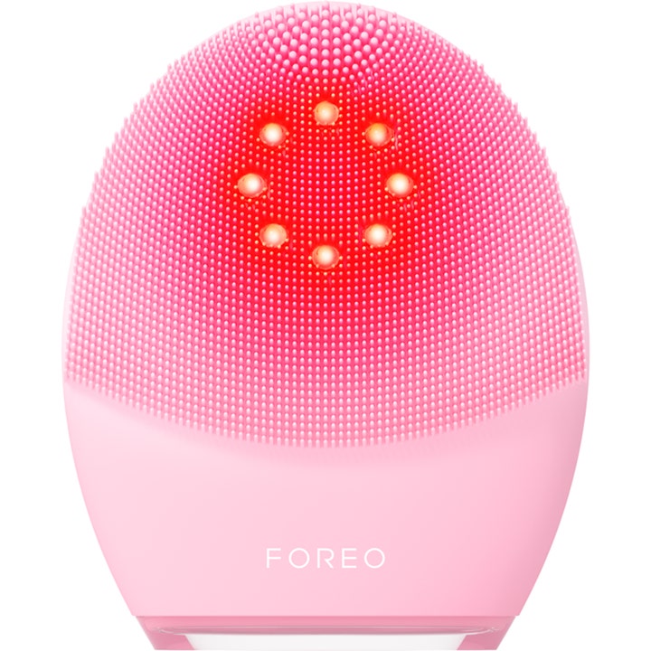 Foreo Luna 4 Plus syväpuhdistava kasvojen puhdistuslaite vaaleanpunaisella silikonipinnalla ja punaisilla LED-valoilla