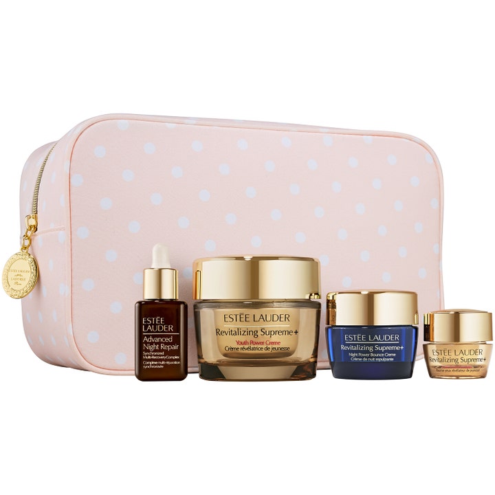 Estée Lauder Revitalizing Supreme+ ihonhoitosetti elvyttää ihoa sisältäen kultaisia voidepurkkeja ja pilkullisen laukun