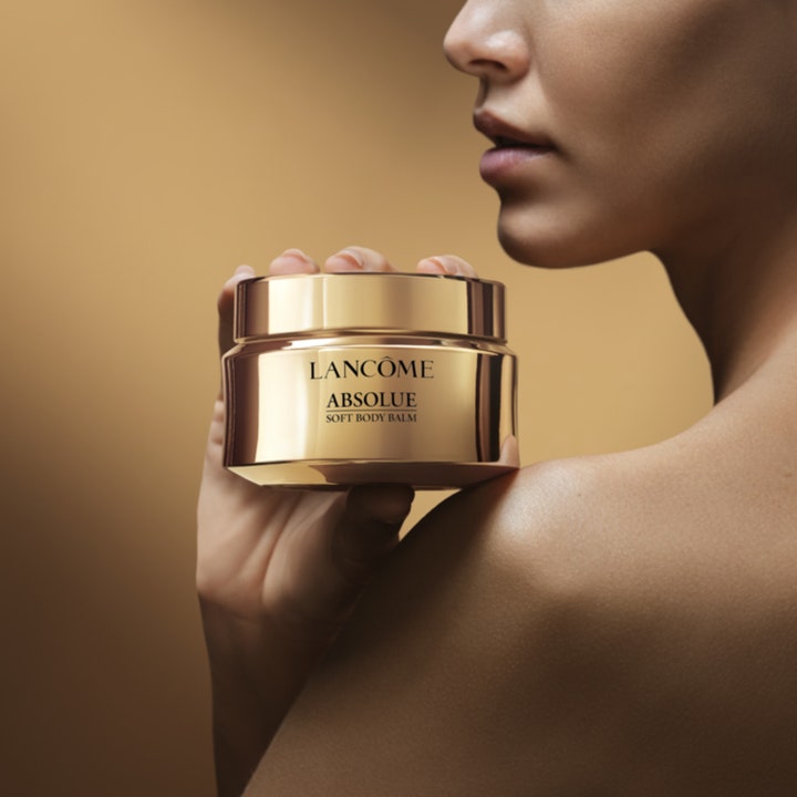 Lancôme Absolue Soft Body Balm 200 ml pehmentävä vartalovoide kultaisessa purkissa naisen olkapäätä vasten