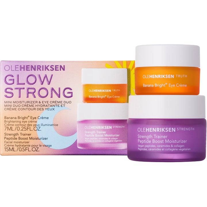 Ole Henriksen Glow Strong 22 ml heleyttävä ihonhoitosetti jossa on oranssi ja lila voidepurkki pakkauksen vieressä