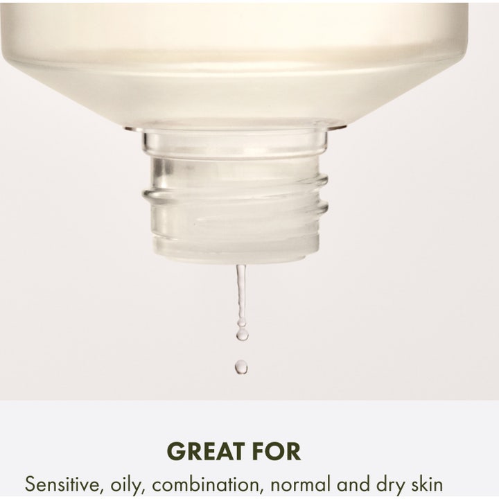 Origins Checks and Balances Daily Exfoliating Toner 150 ml kirkastava kasvovesi ja pullosta tippuva kirkas pisara.