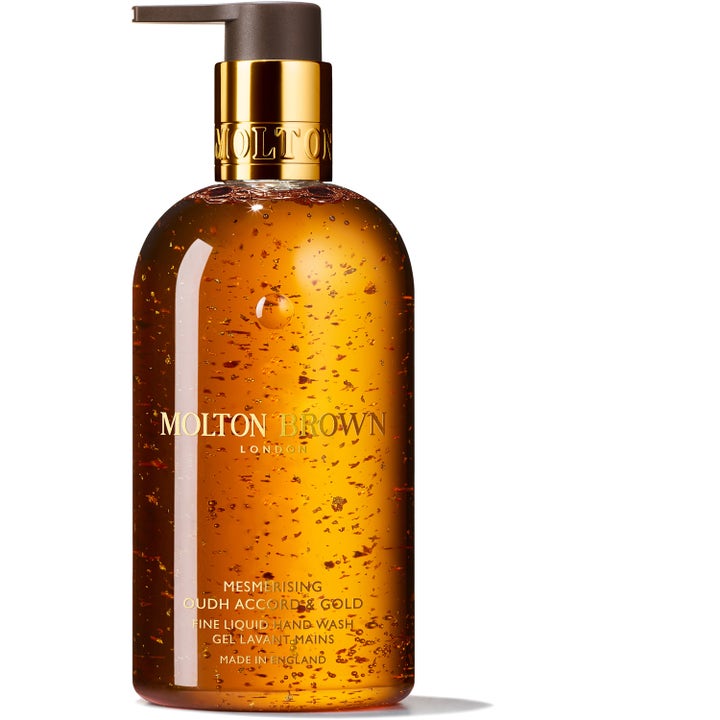 Molton Brown Mesmerising Oudh Accord & Gold 300 ml käsisaippua meripihkanvärisessä pullossa jossa on kultahippuja
