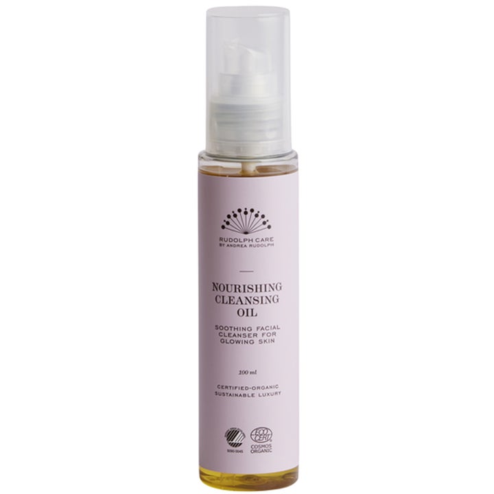 Rudolph Care Nourishing Cleansing Oil 100 ml rauhoittava puhdistusöljy heleyttää ihoa vaaleanliilassa pumppupullossa.