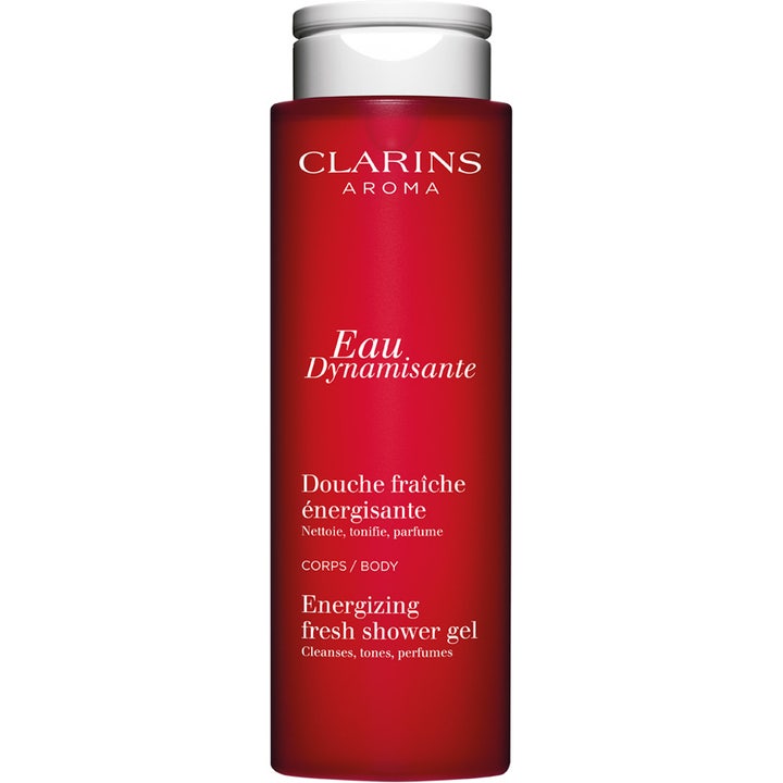 Clarins Eau Dynamisante 200 ml virkistävä suihkugeeli puhdistaa ja sävyttää ihoa punaisessa pullossa valkoisella korkilla.
