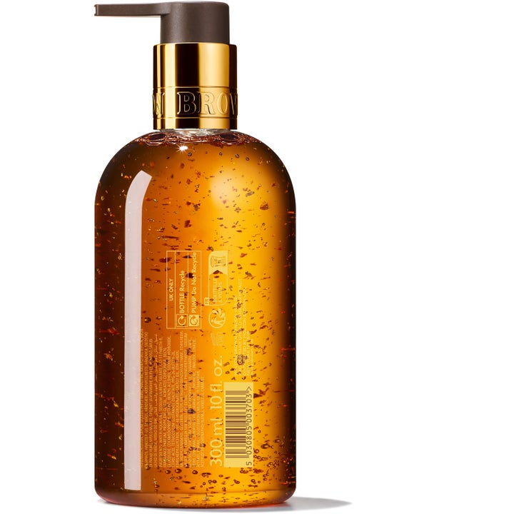 Molton Brown Mesmerising Oudh Accord & Gold 300 ml nestesaippua, jonka ruskeassa pullossa on kultahippuja.
