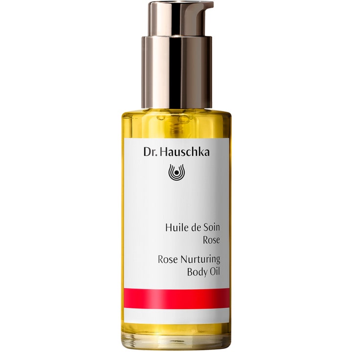 Dr. Hauschka Rose Nurturing Body Oil hoitava vartaloöljy kirkkaassa lasipullossa jossa on keltainen öljy ja hopeinen pumppu