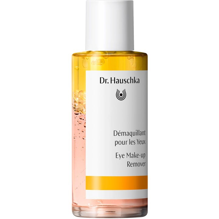 Dr. Hauschka Eye Make-up Remover 75 ml puhdistusaine kaksikerroksisessa lasipullossa keltaisella öljyllä.