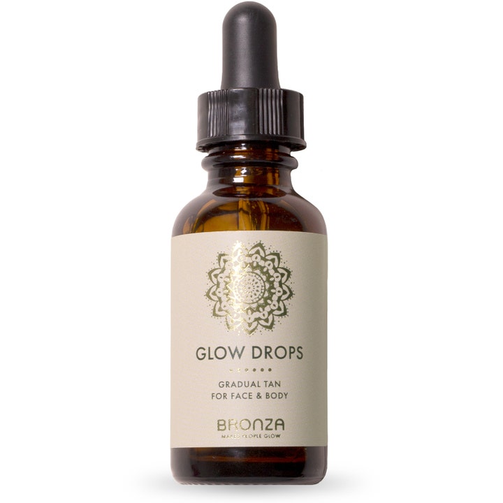 Bronza Glow Drops 30 ml itseruskettava antaa hehkua ruskeassa lasisessa pipettipullossa jossa on kultainen logo.