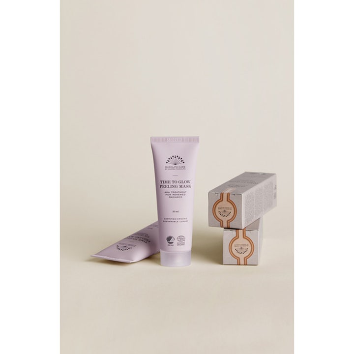 Rudolph Care Time to Glow Peeling Mask 50 ml heleyttävä AHA-kasvonaamio vaaleanliilassa tuubissa ja harmaissa pakkauksissa.