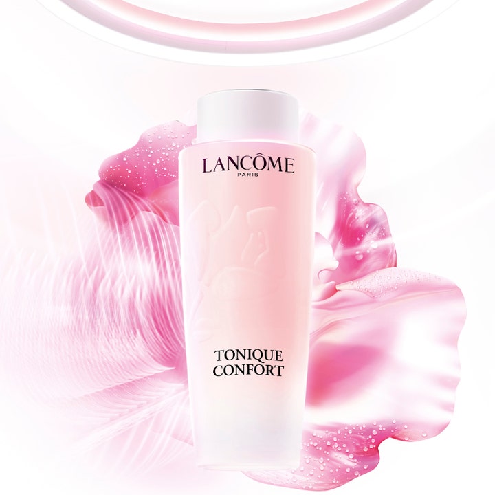 Lancôme Tonique Confort 400 ml kosteuttava kasvovesi vaaleanpunaisessa pullossa kukkivalla taustalla