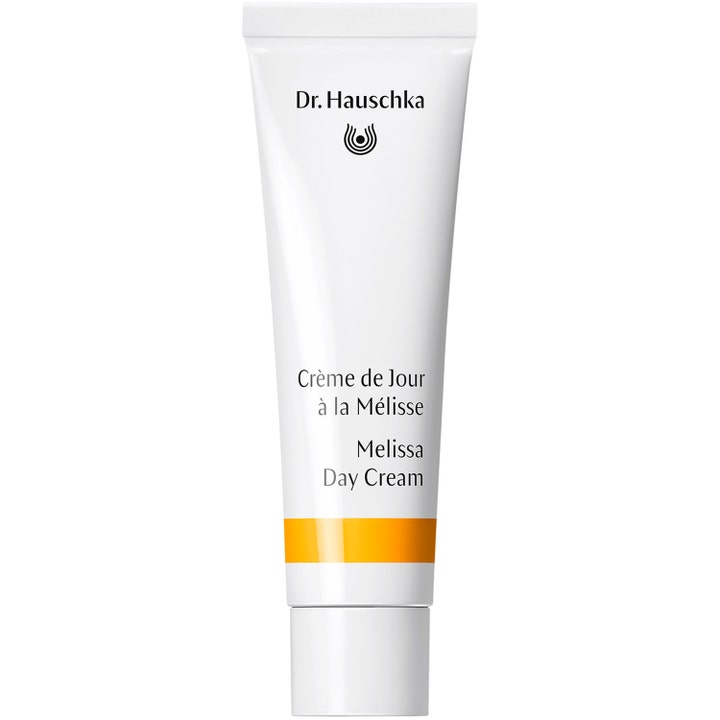 Dr. Hauschka Melissa Day Cream tasapainottava päivävoide valkoisessa tuubissa jossa on oranssinkeltainen raita