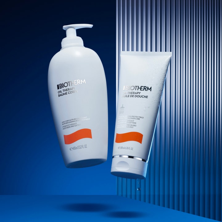 Biotherm Oil Therapy 200 ml kosteuttava suihkugeeli valkoisessa tuubissa vesipisaroilla sinistä taustaa vasten