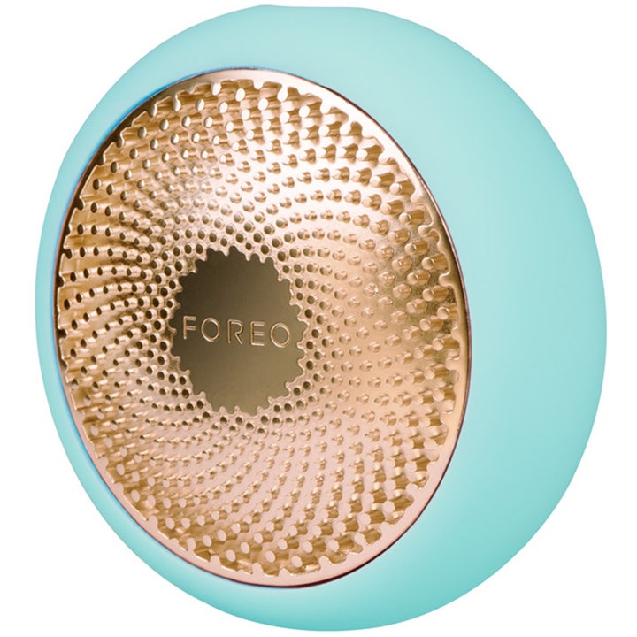 FOREO UFO 2 Mint kasvohoitolaite kirkastaa ihoa mintunvihreä pyöreä laite kultaisella metallipinnalla
