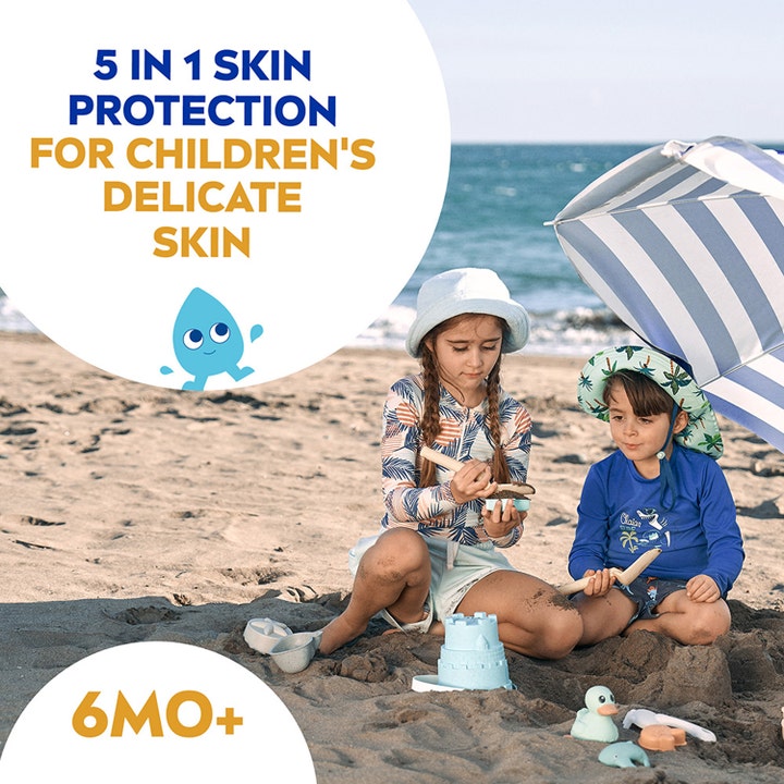 NIVEA Kids Sensitive Protect & Play 270 ml aurinkosuojasuihke lapsille leikkimässä rannalla.