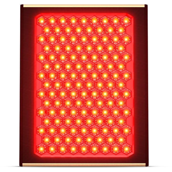 Punavalohoitolaite ihonhoitoon on kennomainen LED-paneeli, joka hehkuu kirkkaan punaisena tyylikkäissä kultakehyksissä.