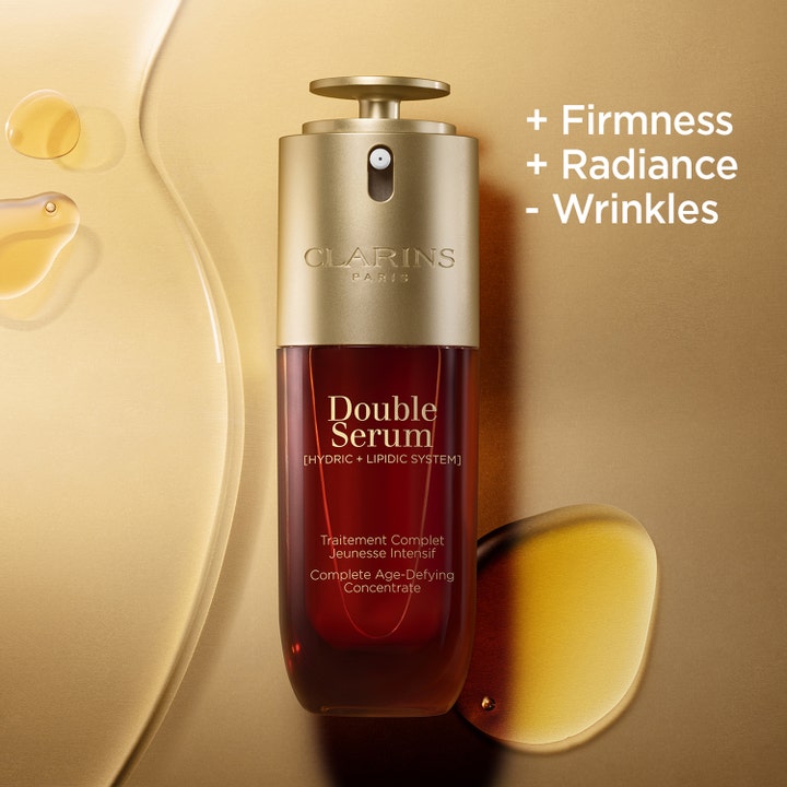 Clarins Double Serum 50 ml kiinteyttävä seerumi kultaisessa pullossa teksteillä Firmness Radiance ja Wrinkles.