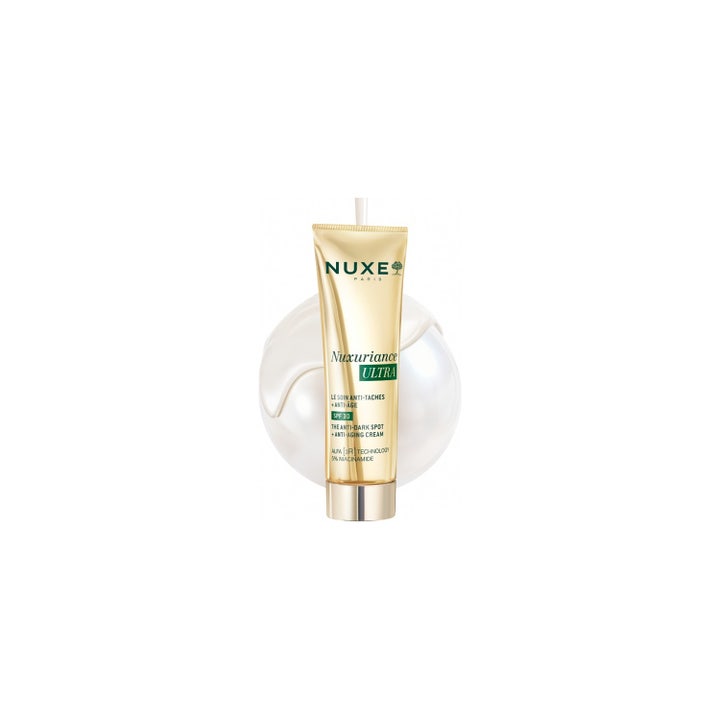 Nuxe Nuxuriance Ultra 50 ml pigmenttiläiskiä vaalentava SPF30 päivävoide kultaisessa tuubissa vaalealla taustalla