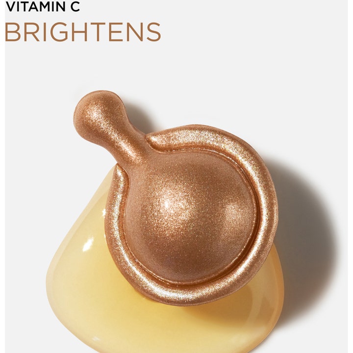 Elizabeth Arden Ceramide Capsules Vitamin C 30 kpl kirkastava seerumi pronssinen kapseli keltaisen tipan päällä.
