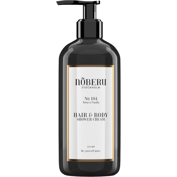Nõberu Hair & Body Shower Cream 500 ml puhdistava suihkuvoide mustassa pumppupullossa, jossa on kultainen reunus.