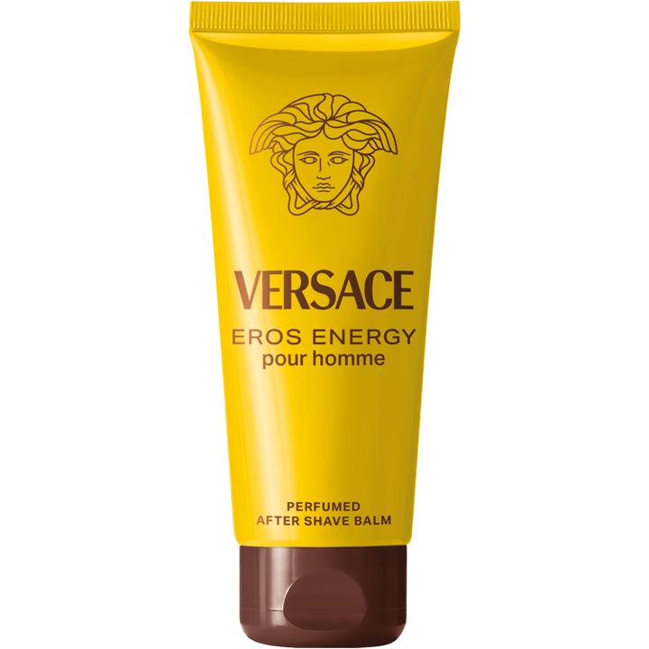 Versace Eros Energy rauhoittava partabalsami keltaisessa tuubissa pronssisella Medusa-logolla ja korkilla.