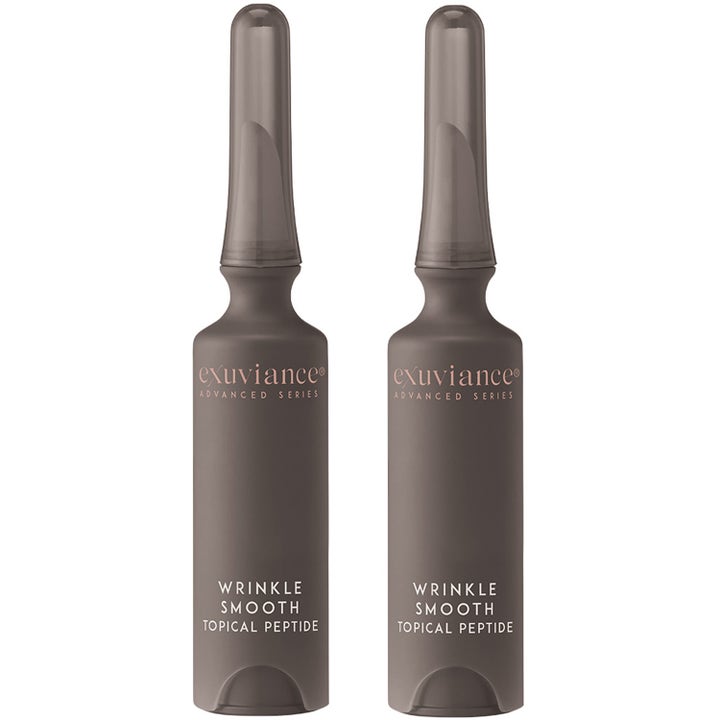 Exuviance Wrinkle Smooth Topical Peptide kaksi ampullia silottava seerumi harmaissa kapeakärkisissä putkiloissa