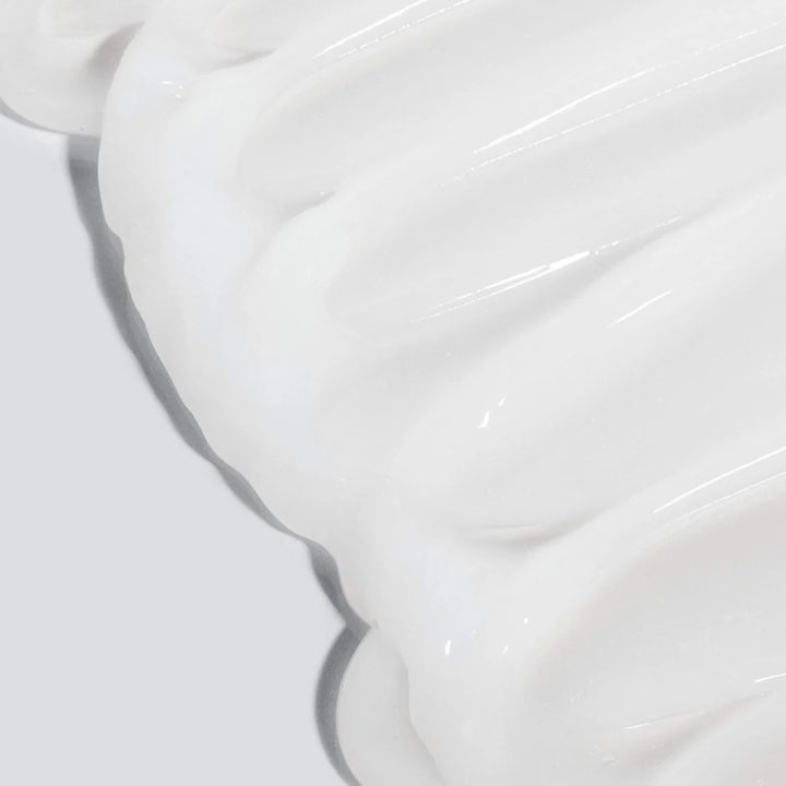 Dermalogica UltraCalming Cleanser 500 ml rauhoittava puhdistusgeeli ja sen täyteläinen, valkoinen voidekoostumus.