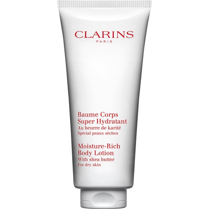 Clarins Moisture-Rich Body Lotion sheavoita sisältävä kosteuttava vartalovoide kuivalle iholle valkoisessa tuubissa.