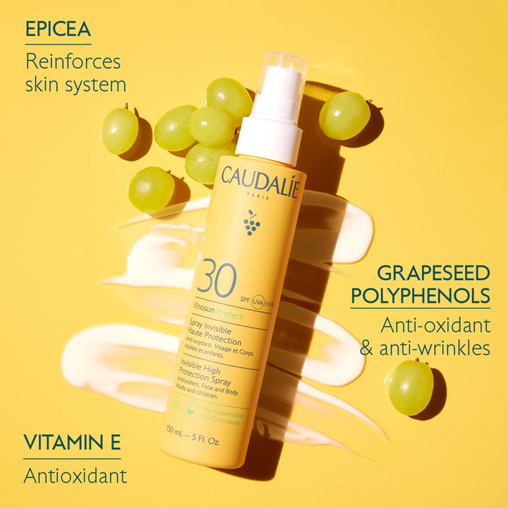 Caudalie Vinosun High Protection Spray SPF30 150 ml antioksidanttinen aurinkosuihke keltaisessa pullossa rypäleiden kera.