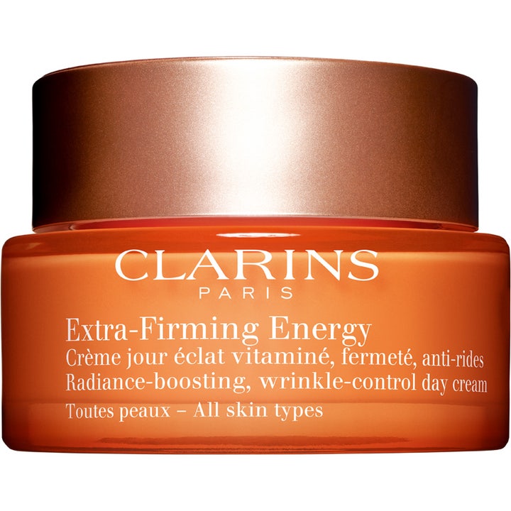 Clarins Extra-Firming Energy 50 ml heleyttävä ja ryppyjä silottava päivävoide oranssissa lasipurkissa kuparikannella.