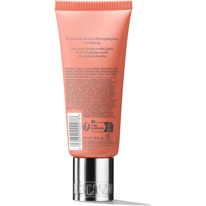 Molton Brown Heavenly Gingerlily Hand Cream 40 ml kosteuttava käsivoide persikanvärisen tuubin takapuoli hopeakorkilla.
