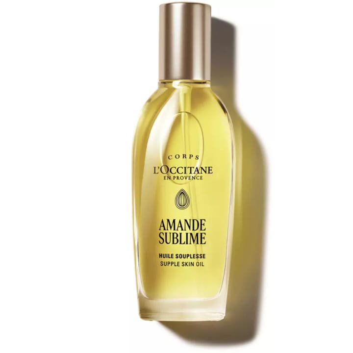 L'Occitane Almond Supple Skin Oil 100 ml pehmentävä vartaloöljy kirkkaassa lasisessa pumppupullossa.