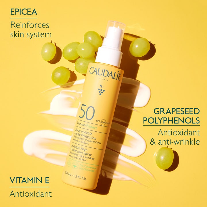 Caudalie Vinosun High Protection Spray SPF50 150 ml aurinkosuojasuihke keltaisessa pullossa viinirypäleiden keskellä