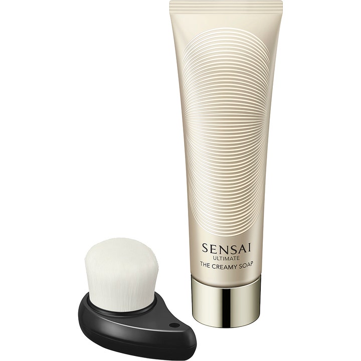 Sensai Ultimate The Creamy Soap 125 ml puhdistussaippua kultaisessa kuvioidussa tuubissa ja puhdistusharja.