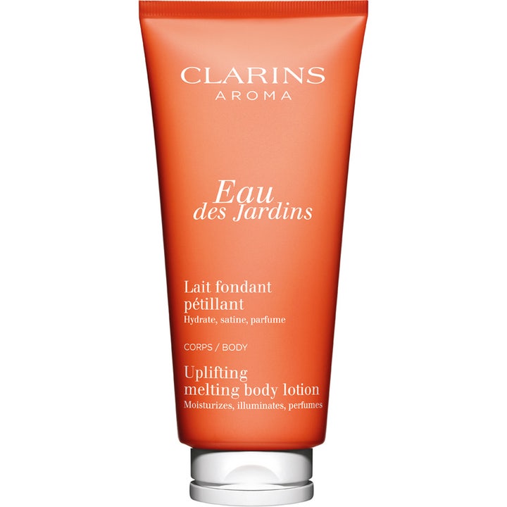 Clarins Aroma Eau des Jardins 200 ml kosteuttava ja heleyttävä vartalovoide oranssissa tuubissa valkoisella korkilla.