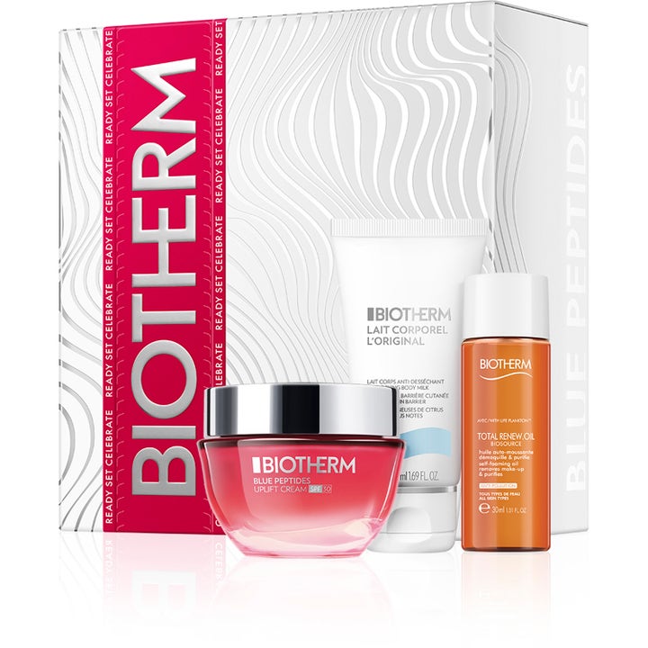 Biotherm Blue Peptides lahjasetti kiinteyttävä kasvovoide pinkissä purkissa sekä vartalovoide ja puhdistusöljy rasiassa.