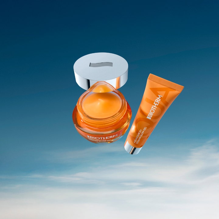 Biotherm Aquasource Vitamin Glow Gel 30 ml heleyttävä kasvovoide oranssissa purkissa ja tuubissa taivasta vasten