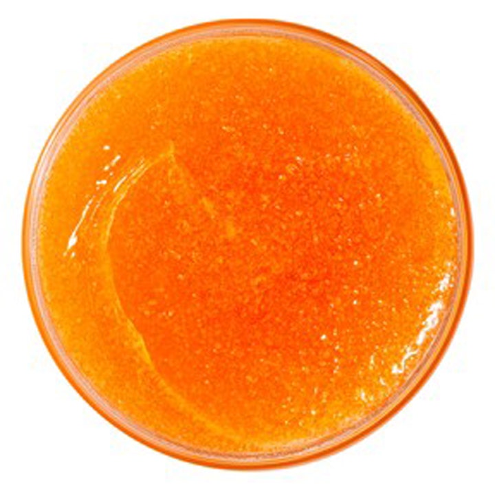 Nuxe Rêve de Miel Body Scrub 175 ml pehmentävä vartalonkuorinta jonka oranssi ja rakeinen koostumus näkyy avatussa purkissa.